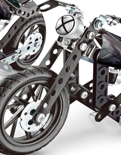 Close-up detail of the front wheel and metal frame of the HotWheel construction motorcycle