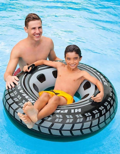 Two kids relaxing and playing in the Intex 56268NP Monster Truck Inflatable Pool Swim Tube