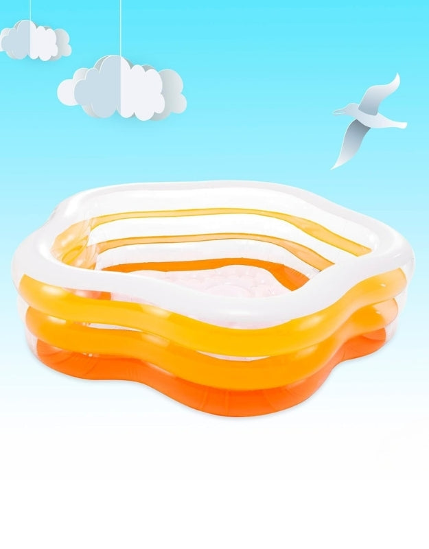 Intex 56495NP Swim Center Summer Colors inflatable pool with bright orange and white layered design outdoors under blue sky.