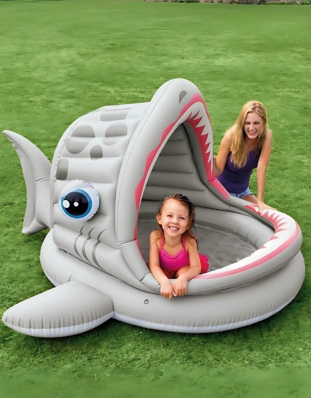 Child and parent enjoying the Intex 57120NP Roarin Shark Shade Pool shaped like a shark with canopy shade, outdoor use