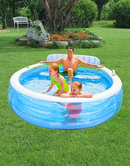 A father and two children enjoying the Intex 57190NP Swim Center Family Lounge Pool outdoors on the grass.