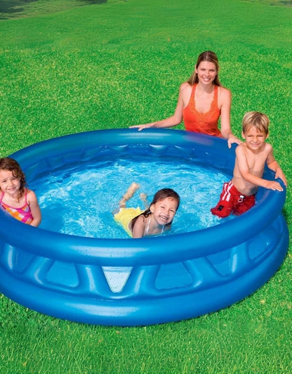 A family enjoying the blue Intex inflatable swimming pool with a ribbed design