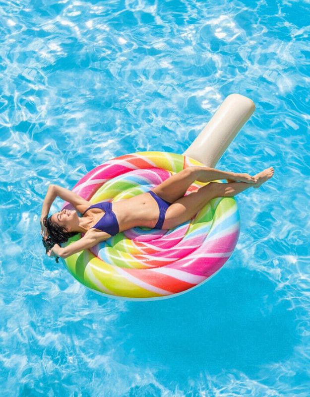 Woman relaxing on Intex 58753EU colorful lollipop inflatable float in a swimming pool.