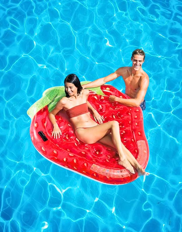 Couple relaxing on Intex 58781EU inflatable strawberry-shaped pool float, 168x142cm size, in bright blue water.
