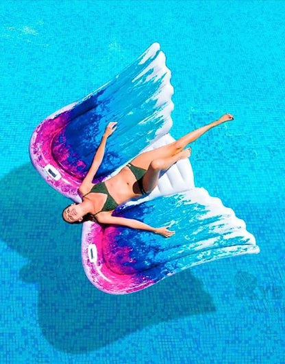 A person holding the Intex inflatable Angel Wings raft to show its size.
