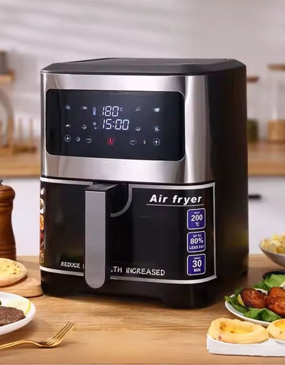 A black air fryer with digital display and touch control panel, surrounded by recently cooked food items on a wooden table.