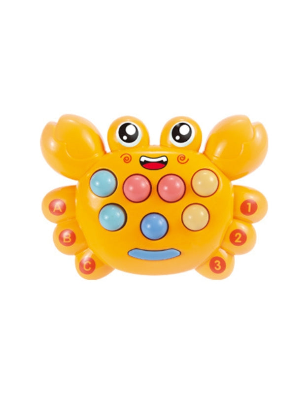 A young child smiling while playing the electronic Whack-a-Mole game toy, holding a yellow mallet