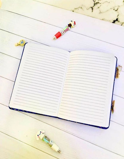 Open notebook with lined pages on a wooden surface