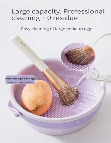 Makeup brush and sponge being washed in purple cleaning bucket with textured surface.