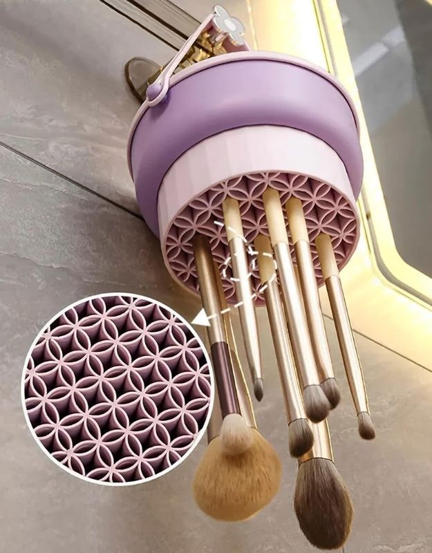 Hanging makeup brushes upside down in purple drying holder bucket after washing.