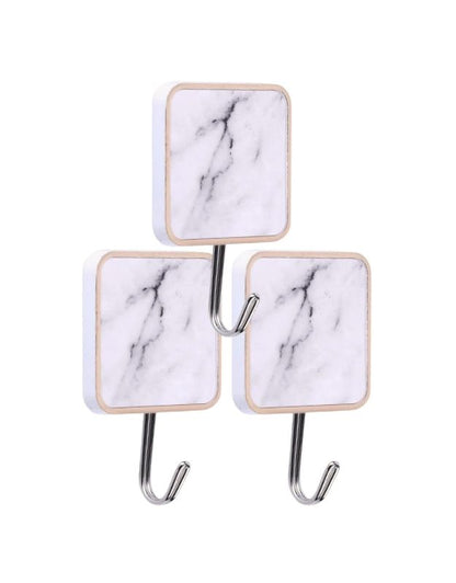 Square marble adhesive wall hooks for bathroom and kitchen organization.