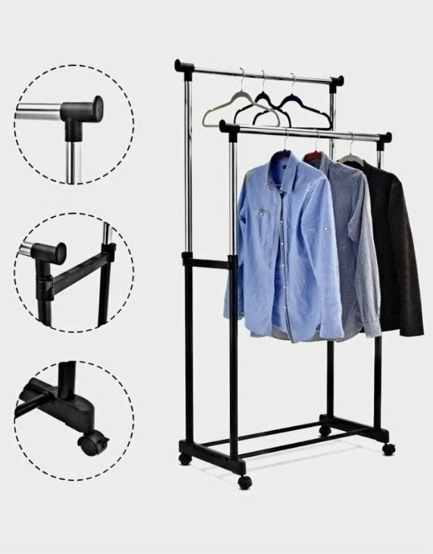 Detail view of adjustable metal garment rack with wheels and hanging shirts.