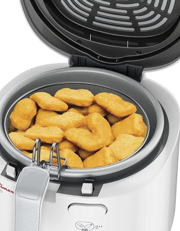 Moulinex electric deep fryer open with golden chicken nuggets inside frying basket