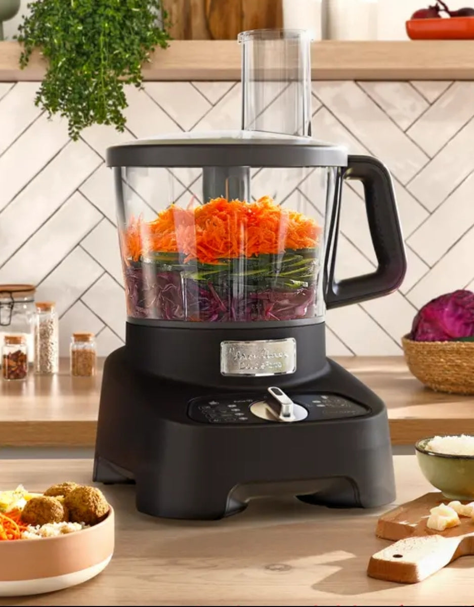 Moulinex Double Force multifunction robot processing fresh vegetables on a modern kitchen counter