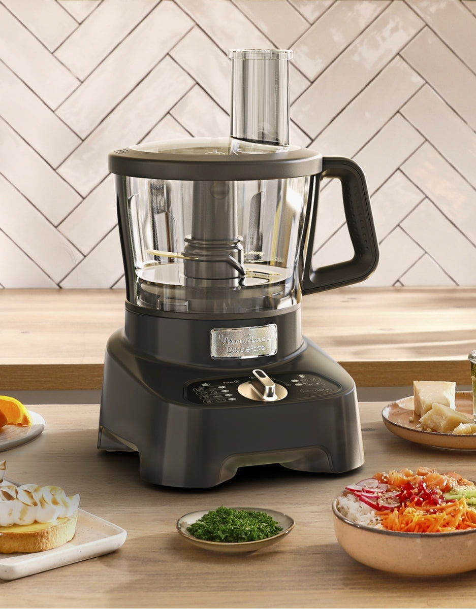 Moulinex Double Force multifunction kitchen robot on counter surrounded by ingredients, ideal for chopping, mixing, and blending