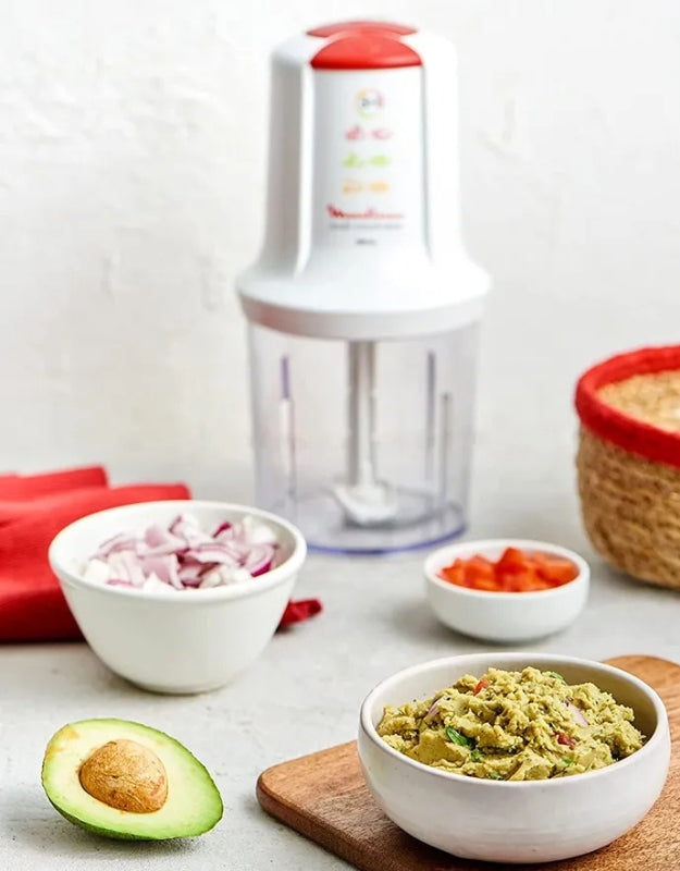 Moulinex Moulinette 500ml white chopper on kitchen counter with chopped vegetables and avocado dip preparation
