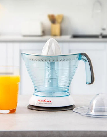 Moulinex Vita Press Juicer 1 L in modern kitchen with glass of orange juice and transparent cover beside it
