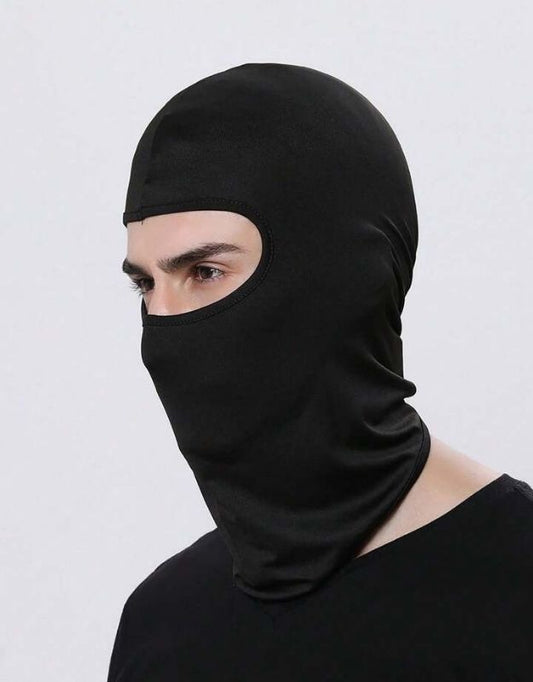 A person wearing a black full face mask covering the head and neck, suitable for cold-proof and wind-proof cycling.