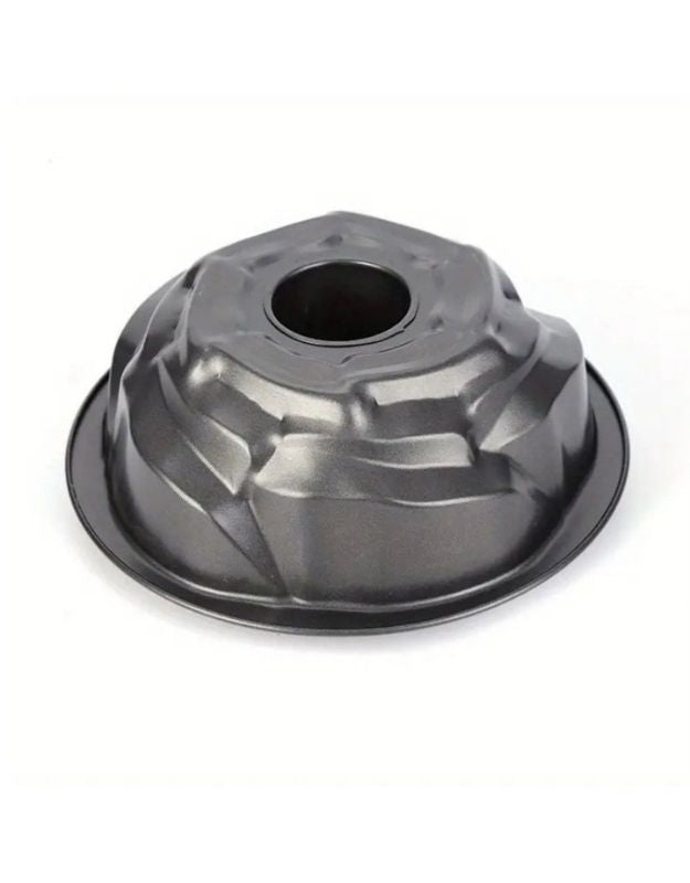 Metallic gray cake mold on a white background. Nonstick black bundt cake pan with geometric design, top view.