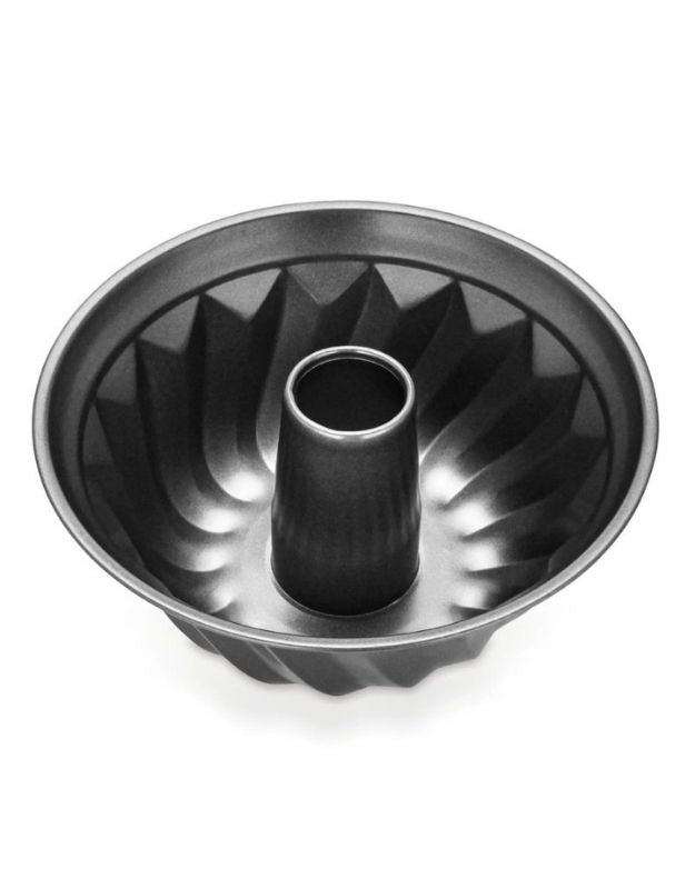Metal bundt cake pan on a white background. Non-stick fluted Bundt cake pan with central tube for even baking.