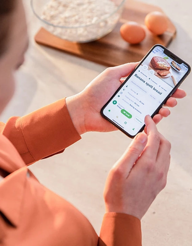 User browsing Philips airfryer recipe app on smartphone.