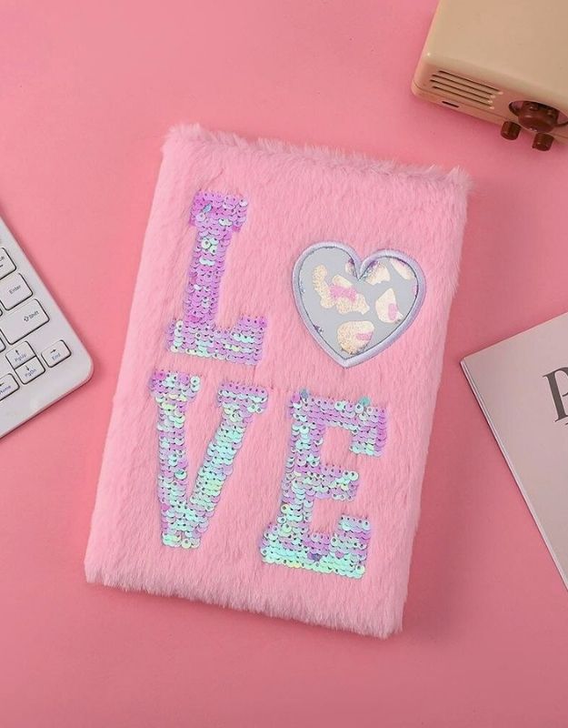 Pink fluffy notebook with 'LOVE' in iridescent letters on a pink background