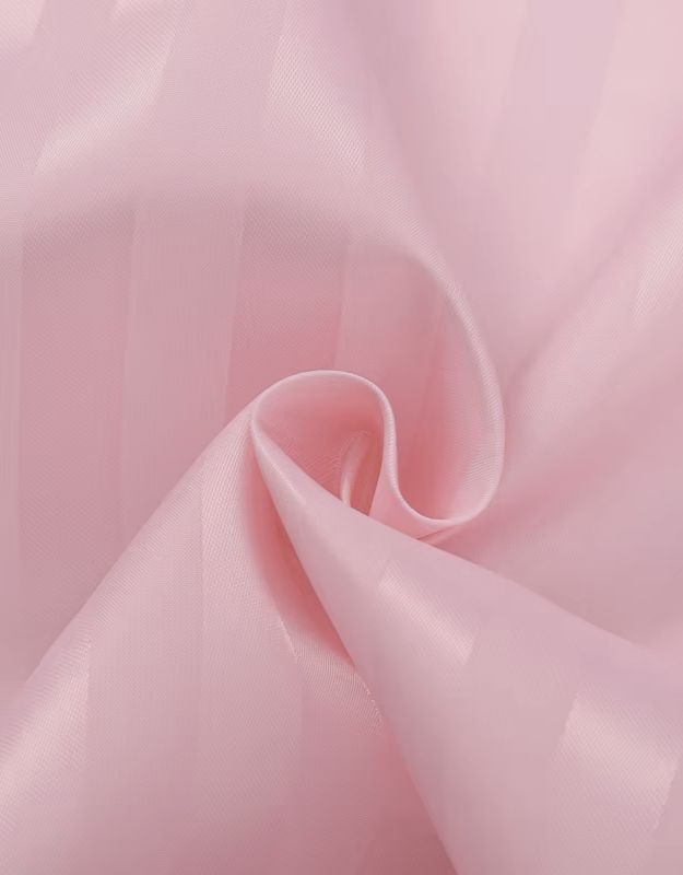 Pink striped shower curtain fabric closeup with soft folds.