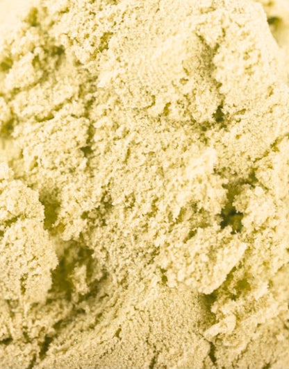 A detailed, close-up shot showing the unique texture of green or light yellow play sand