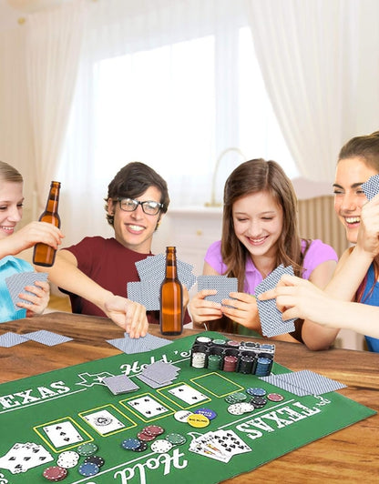  A group of friends laughing and playing a game of Texas Hold'em poker with the set on a wooden table