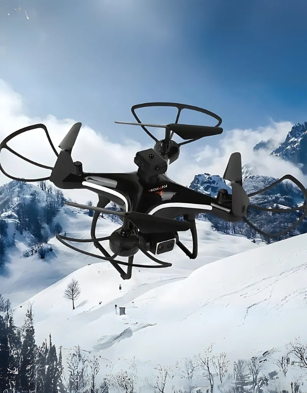 Quadcopter drone flying outdoors in snowy mountains