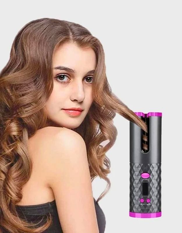 Woman styling curly hair with rechargeable auto ceramic barrel hair waves curler 34W.