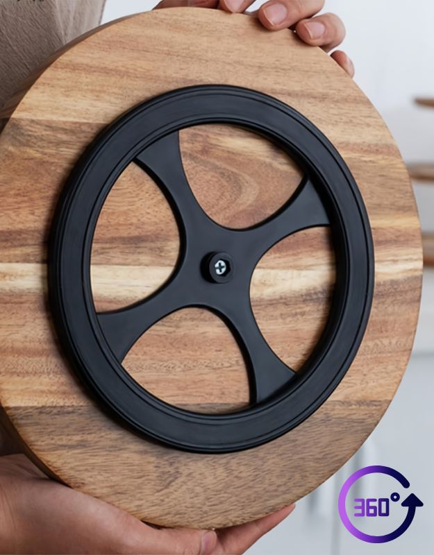 Wooden circular product with black central wheel design held by hands. Wooden round chopping board with 360-degree rotating base.