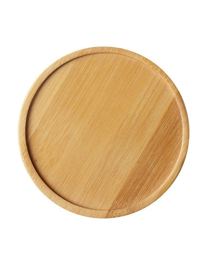 Wooden plate on a white background. Empty round bamboo serving plate with natural wood grain finish.