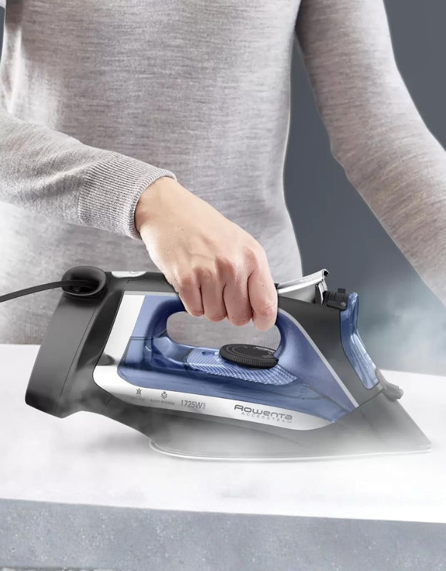 Person using Rowenta Access steam iron to press fabric smoothly with strong continuous steam output