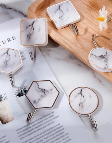 Set of marble design adhesive wall hooks in square, round, and hexagon shapes.