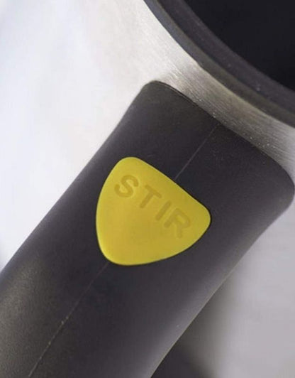 Close-up of yellow stir button on self-stirring mug handle.