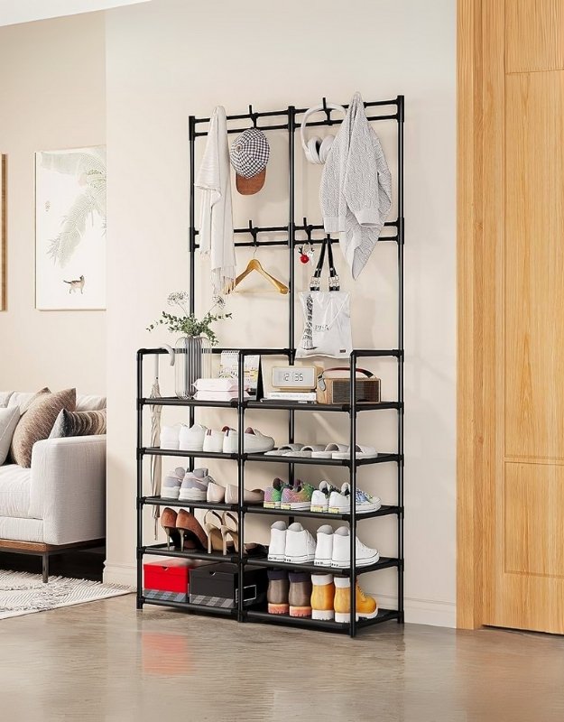A black metal shoe rack with coat and clothes hanger features in a home setting.