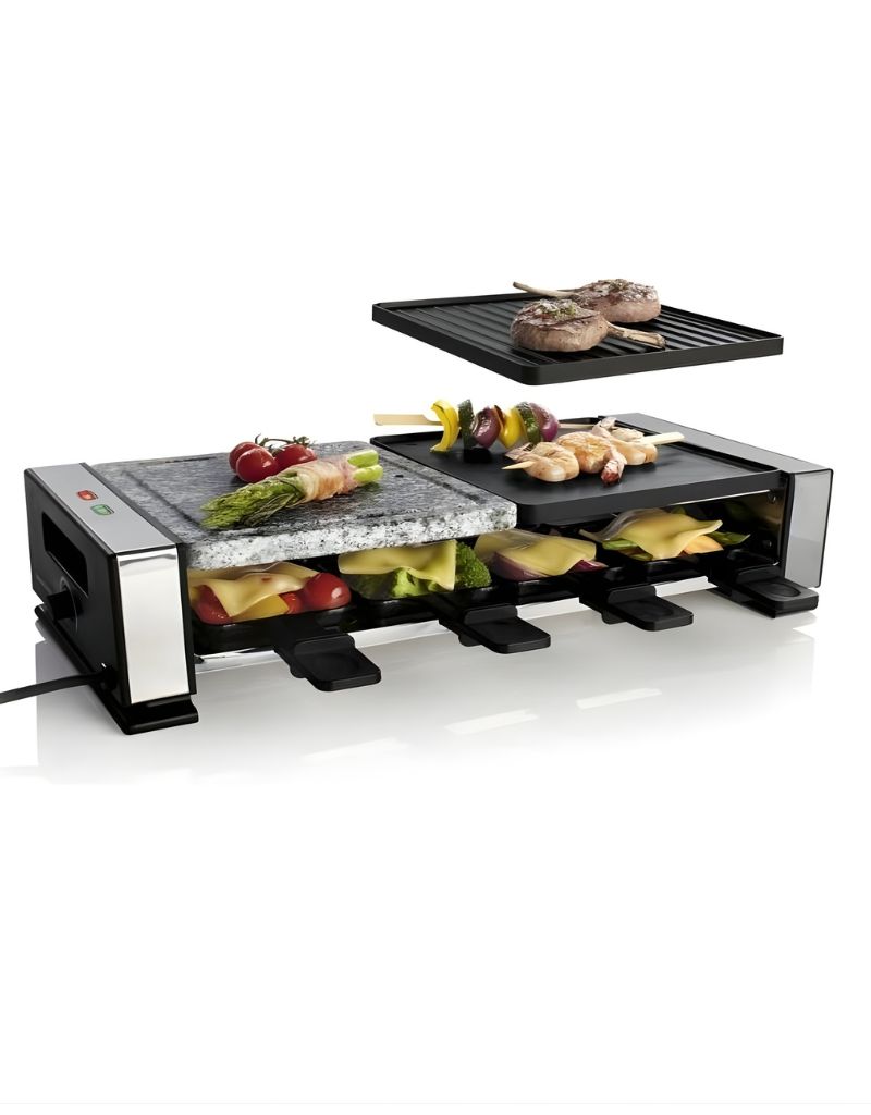 Silver Crest 1400W Raclette Grill with hot stone and non-stick plates grilling meat and vegetables with melted cheese trays below
