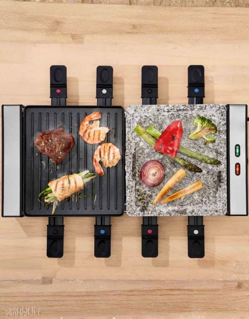 Top view of Silver Crest Raclette Grill 1400W cooking meat and vegetables on stone and grill sides
