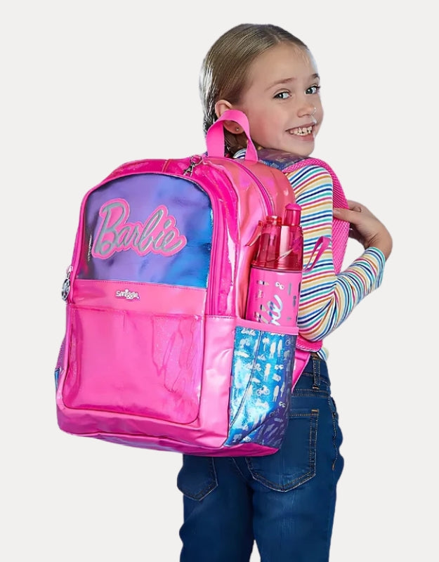 Girl smiling while carrying Smiggle 15-inch Barbie Large Backpack in pink and blue