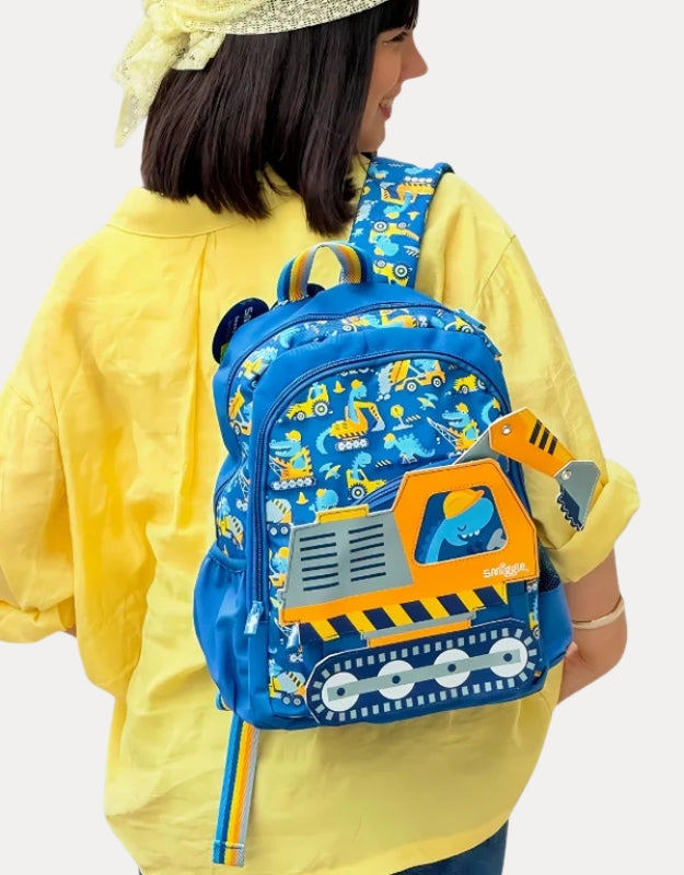 Child wearing a Smiggle Big Dreams Junior Character Backpack with a colorful construction vehicle design, shown from the back