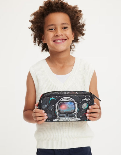 Smiling child showing Smiggle Eclipse Pencil Case with astronaut space print