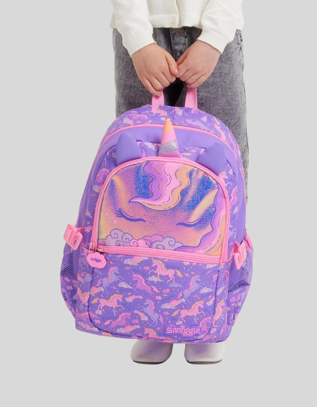 Child holding Smiggle Lilac Eclipse Classic Attach Backpack with unicorn horn and ears design in purple and pink
