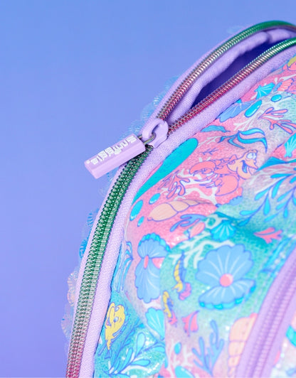 Close-up of the backpack's zipper with Smiggle branding and pastel aquatic pattern showing characters like Flounder and Sebastian.