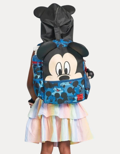 Little girl wearing a colorful dress carrying a Smiggle Mickey Mouse Print Hooded Backpack with attached black hood featuring mouse ears.