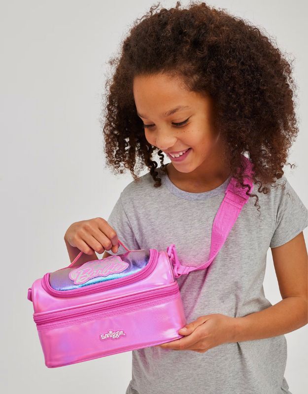 Child holding Smiggle Pink Barbie Double Decker Lunchbox with strap