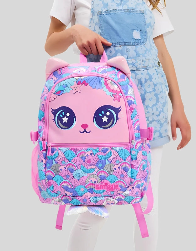 Girl holding a Smiggle 15-inch pink cat face attach school backpack with lunchbox attaches