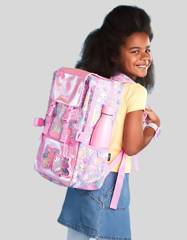 Girl wearing Smiggle 17.7 inch pink foldover school backpack with smiling flower design