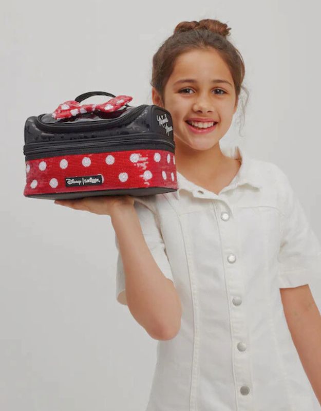 Child holding Smiggle Red Minnie Mouse Double Decker Lunchbox with polka dot bow design