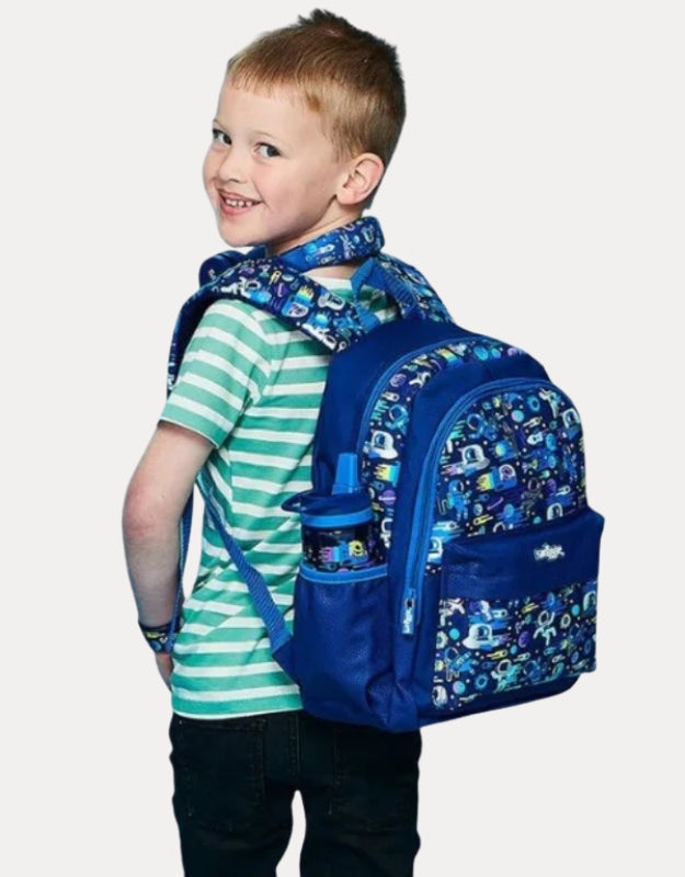 Smiggle small backpack with blue space astronaut design worn by a boy in striped shirt.